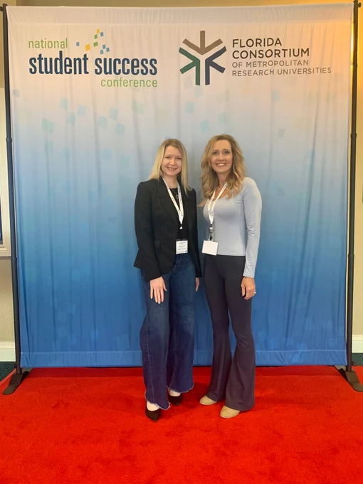 Two women are positioned in front of a banner that says "Student Success," highlighting their dedication to academic excellence.