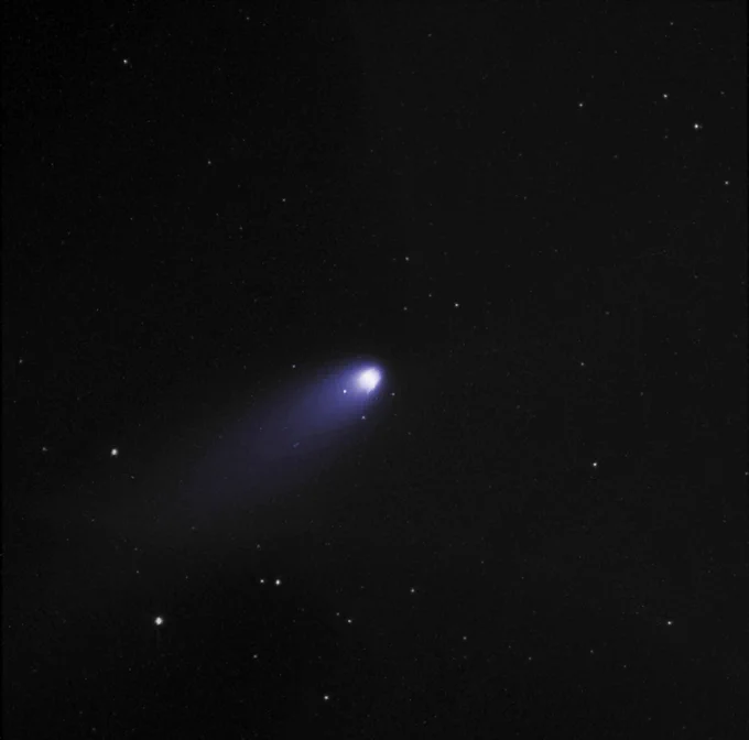 A comet floats in orbit against a background of stars.