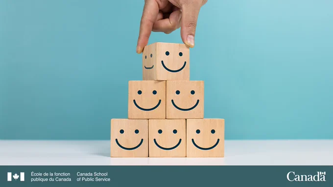 lmage représentant une main qui empile des blocs sur lesquels sont dessinés des sourires.