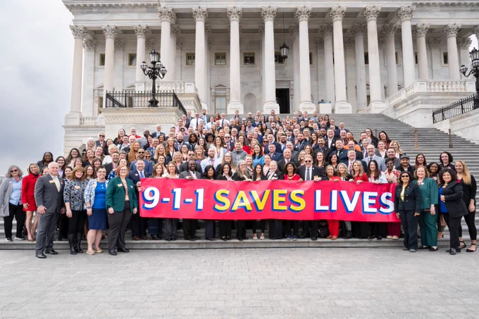Group of 100  9-1-1 responder personnel from different areas of the United States, huddled for a photo on the U.S.Capitol steps, while attending the NENA: 9-1-1 Association “9-1-1 Goes to Washington” convention.