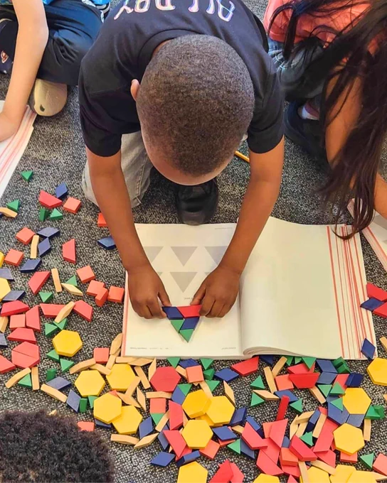 A student is using manipulatives while working in the Eureka Math² workbook.