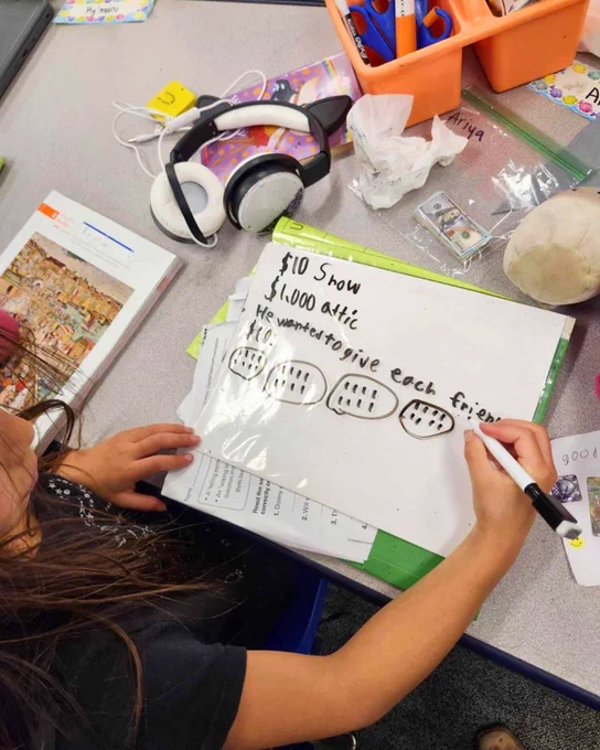 Student writing out a solution to Eureka Math² problem. 