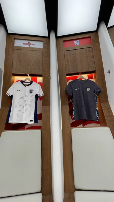 The signed Lionesses home and away shirts are hung up on display in the Wembley dressing rooms.