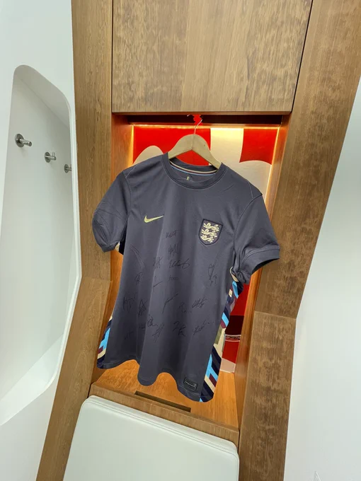 The signed Lionesses away shirt is hung up on display in the dressing room.