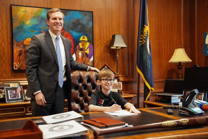 An image of Seth Walsh sitting at the Governor's desk.