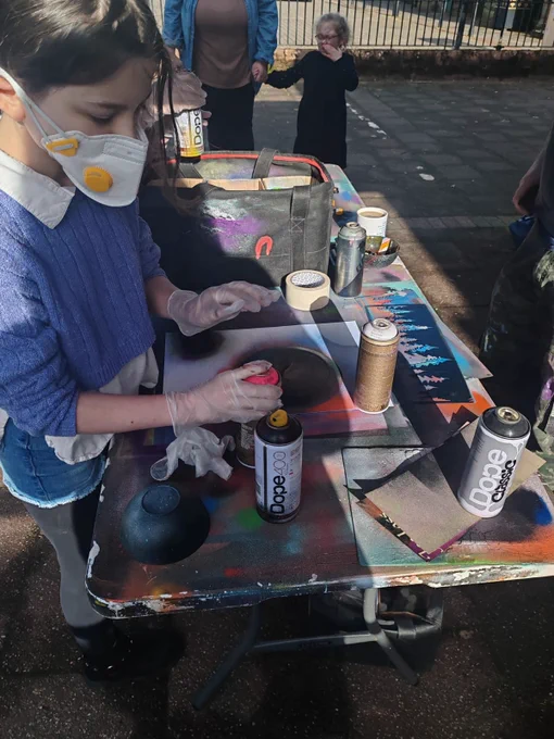 A young participant has a go at spray painting.