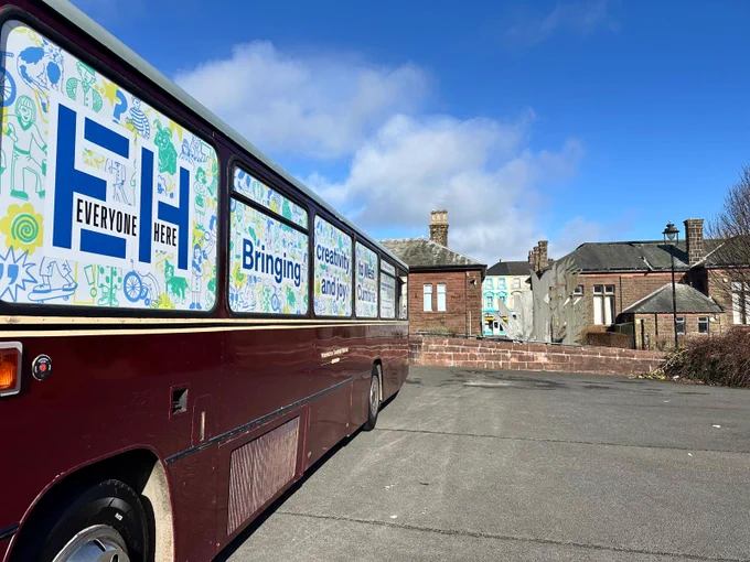 The Spark Bus parked in the Cleator Moor Civic Hall car park in the sunshine.