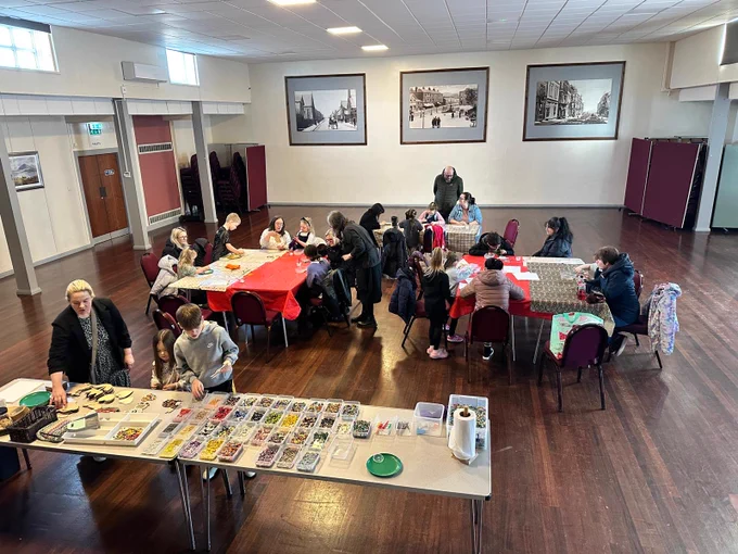 Community members gets stuck into the mosaic-making workshop.