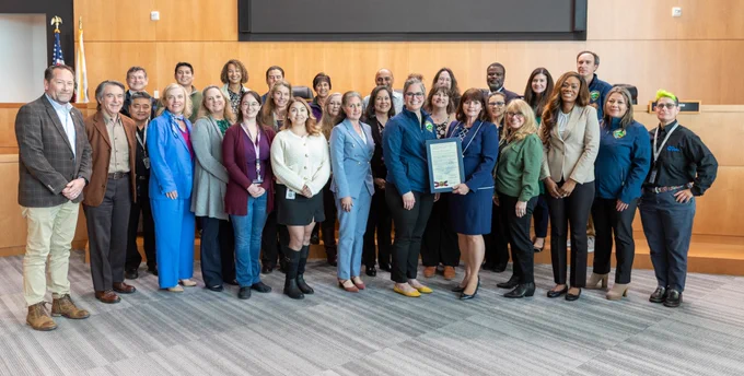 Contra Costa County’s Board of Supervisors stand with public information officers to honor Government Communicators Day in Board Chambers in Martinez, California, on Tuesday, February 25, 2025.