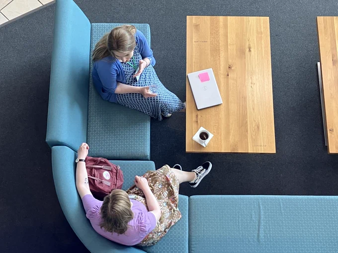 Two people chatting on a sofa