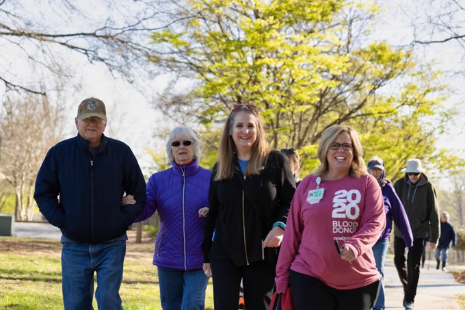 Community members, Duke staff, and healthcare providers stroll in a park during Walk with a Doc.