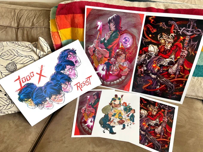 Photo of the same prints but without my face in it. This photo also shows that the Mouthwashing and Elden Ring prints are available in two sizes. 