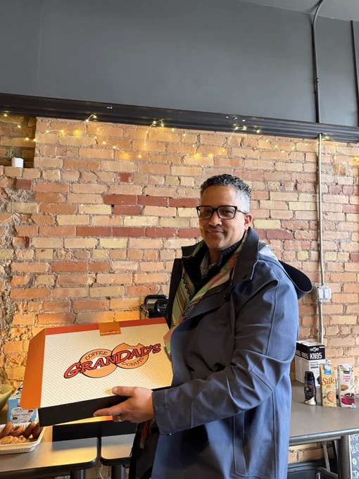 Matthew Green in the campaign office with Grandad’s doughnuts