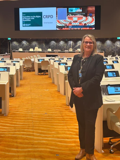 President and CEO of CCRW, Maureen Haan standing inside the UN smiling for camera