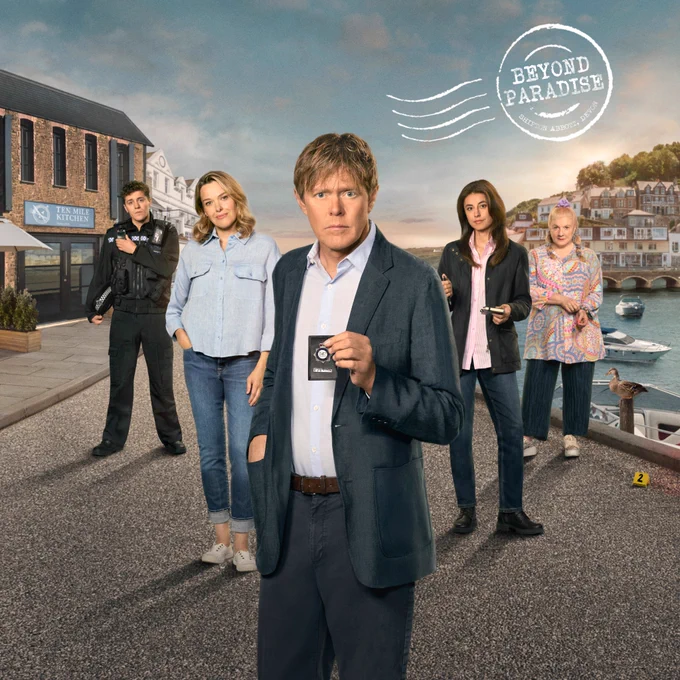 Key art for Beyond Paradise series three. Featuring five characters from the series stood beside the docks in Shipton Abbot. Characters include PC Kelby Hartford, Martha Lloyd, DI Humphrey Goodman, DS Esther Williams, and Margo Martins. 