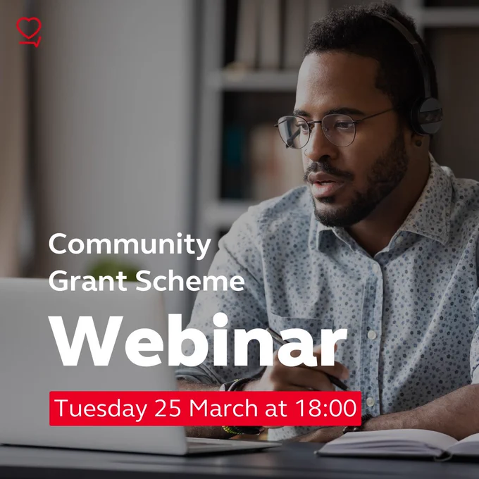 Man sitting at a table in front of a laptop with a headset on. Text on the image reads "Community Grant Scheme Webinar: Tuesday 25 March at 18:00"
