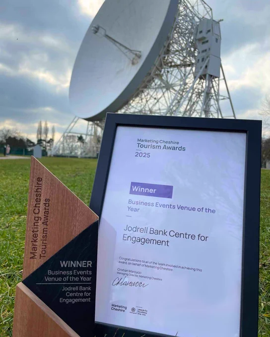A photo of the award in front of the Lovell Telescope.