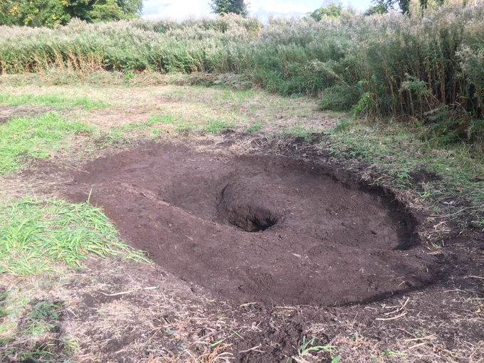How the scrape started back in September 2022. An area of Great Willowherb initially cleared and a shallow sloping scrape dug out by hand by local volunteers