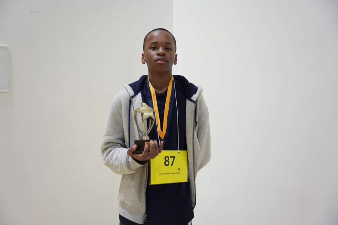 A student holds his trophy after the Spelling Bee Championships.