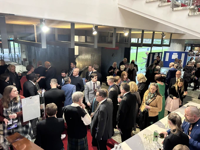 Photo showing the foyer area with guests mingling.