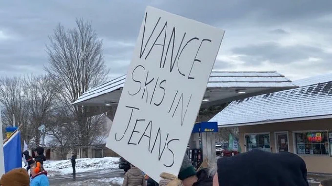 Placard from the vermont protest reading "vance skis in jeans"