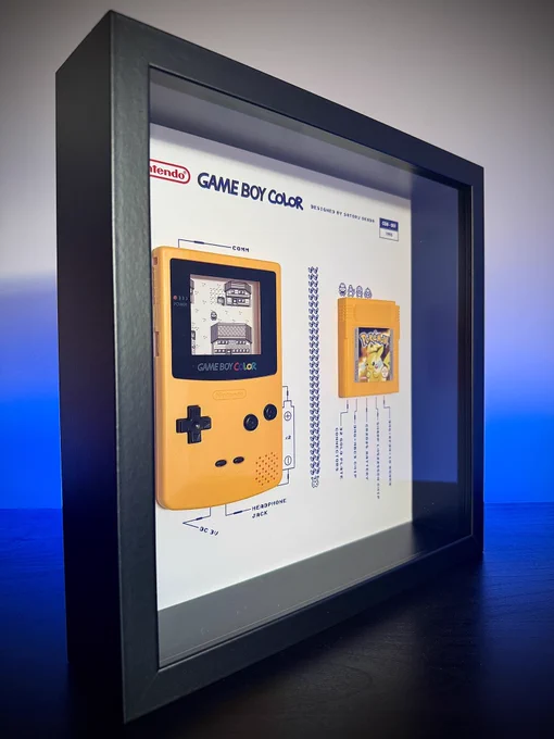 A yellow Game Boy Color on display with a yellow Pokemon cartridge