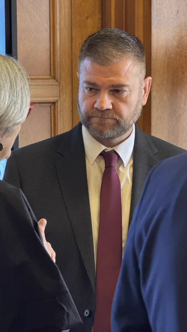 Close up of Colin speaking with Ann McBrien