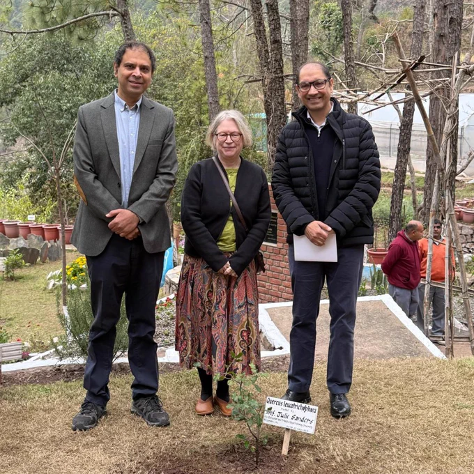 Professor Julie Sanders and staff from Shoolini University stand behind plant