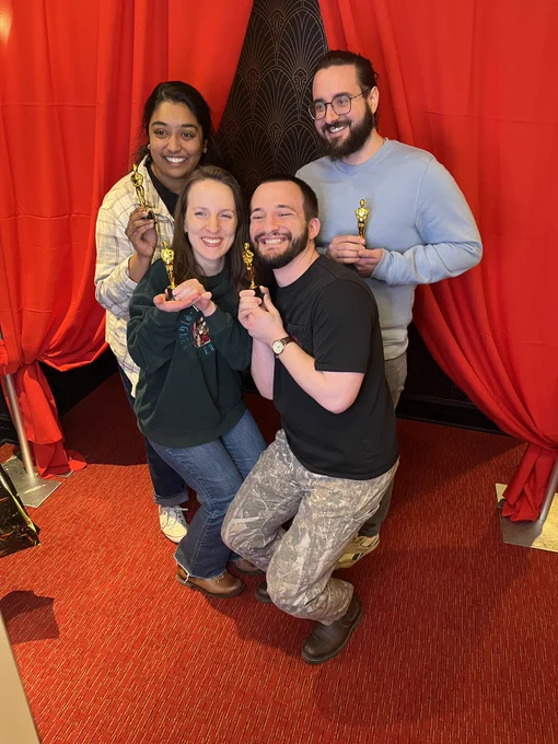 Four people with fake Oscars