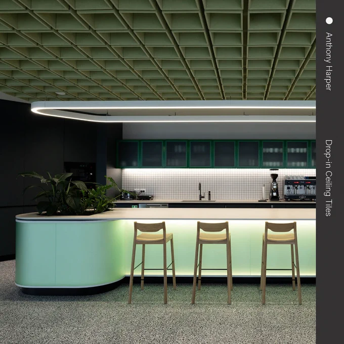 A modern kitchen with a curved, mint green counter featuring three high stools in front of it. The kitchen has a tiled backsplash and is illuminated by a large, circular overhead light. Decorative plants add a touch of greenery to the space.