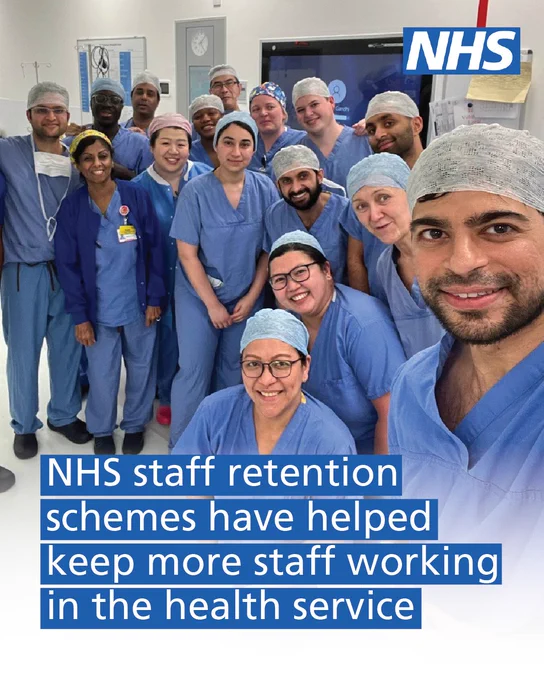 NHS staff retention schemes have helped more staff working in the health service. An image of a group of NHS staff in blue scrubs all smiling is shown.