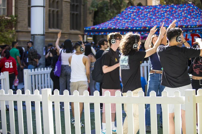 Students dancing to the silent disco with headphones on.