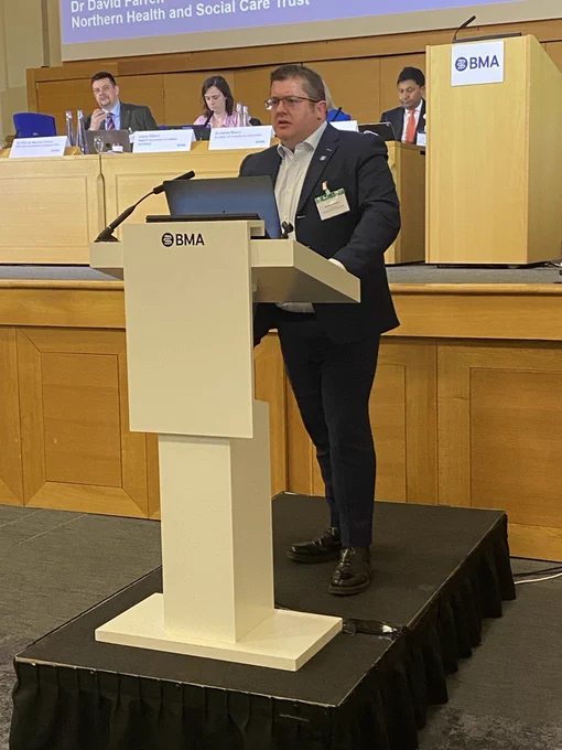 an image of David Farren speaking from a podium 
