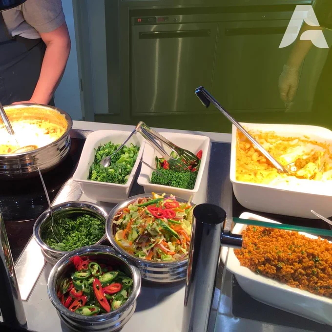 Hot food counter with various food dishes on