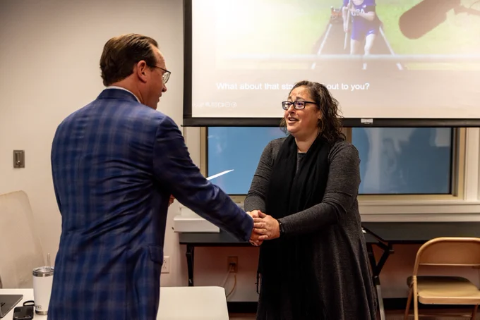 Two people shake hands