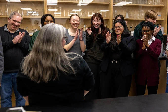 Students clap for a professor