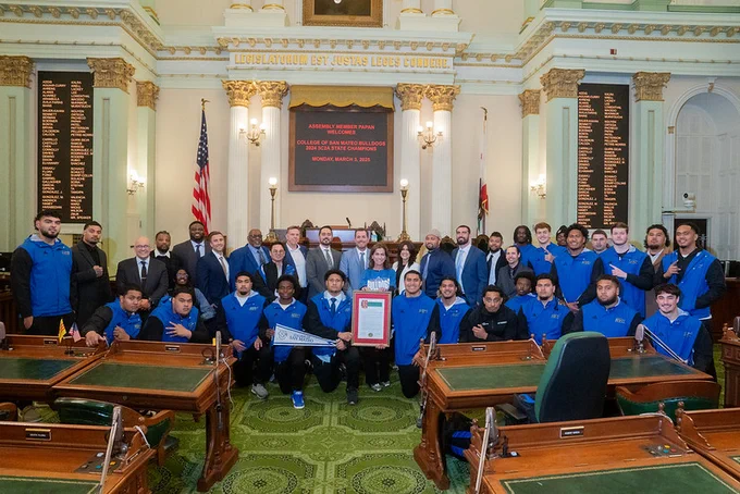 Assemblymember Papan pictured with the coaches and team members of the College of San Mateo Bulldogs football team.