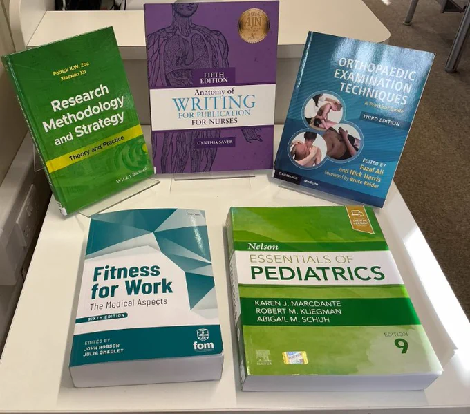 Five books displayed on a white table. These are new books which have been added to the UCL Institute of Orthopaedics Library Collection. 