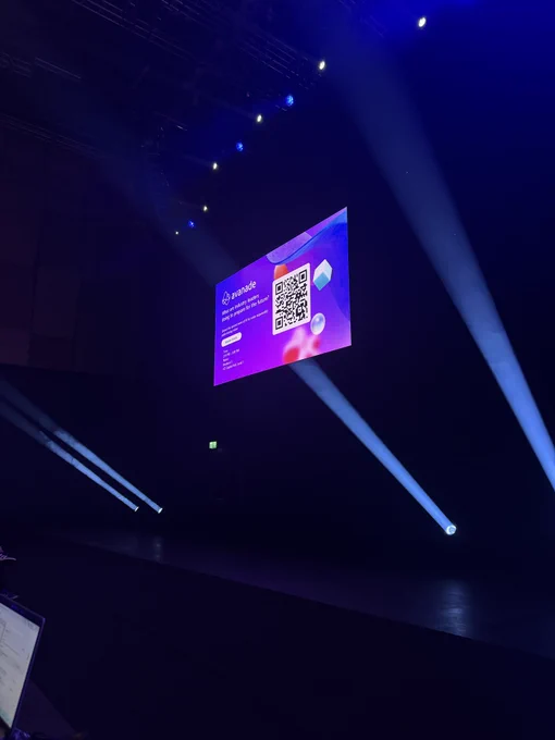 Screen with QR code and branding. Light beams