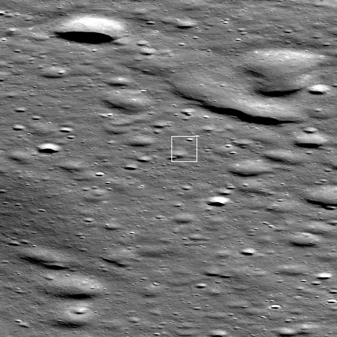 Full resolution oblique view of Firefly's Blue Ghost Mission 1 landing site on the Moon. The grey cratered surface of the Moon is shown with a white box outlining the landing site near the center. The lander itself is seen as a bright pixel casting a shadow in the middle of the box.