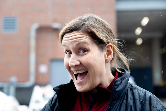 Bates women's basketball head coach Alison Montgomery smiles and poses for the camera before she boards the bus to the NCAA DIII National Championship tournament in Scranton, Pa.