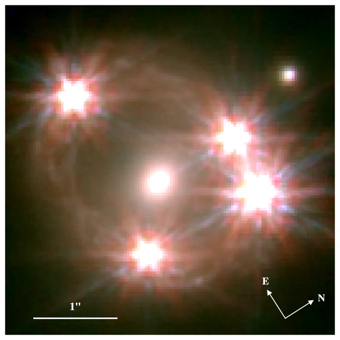 JWST NIRCam color image of WFI2033-4723 (GTO Program #1198; PI: Stiavelli). The F115W band is mapped to the luminosity and blue, F150W to cyan, F277W to yellow, and the F356W band to red. Near the bottom image, there is a bright spot on the lower-right side that maps back to other bluer regions of the ring, indicating it is a multiply-imaged star-forming region (SFR) contained in the z∼1.6 host. Preliminary models place the physical size at ∼150pc located ∼2kpc from the center of the galaxy (assuming flat CDM cosmology with h = 0.7 and m = 0.3).