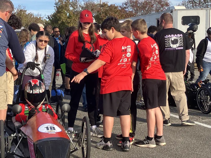 Hampton Cove Greenpower students push their car on the track to start it