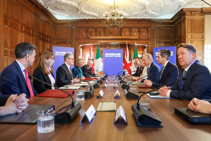 Prime Minister Keir Starmer and Taoiseach Micheál Martin sitting at a table with their Government Ministerial Councils at the UK and Ireland Summit.