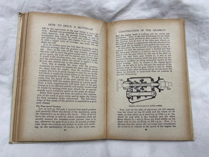 A colour photograph of some pages from the book 'How to Drive a Motorcar'. These pages describe the construction of a gearbox. 