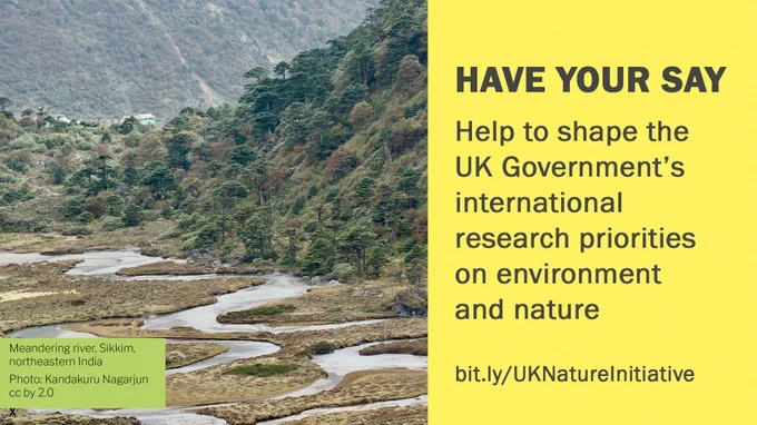 Have your say - help to shape the UK government's international research priorities on environment and nature. Image: Meandering river in a mountainous valley bordered with trees, and houses in the distance.