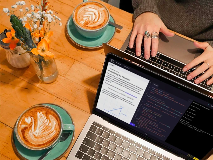 Two people are sitting at a cafe, drinking lattes and working through their Codecademy courses. 