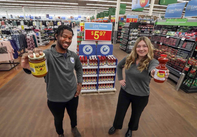 Nova Scotia Loyal brand ambassadors Aljero Knowles and Taylor Dominic hold local products at the Walmart in Bedford. 
