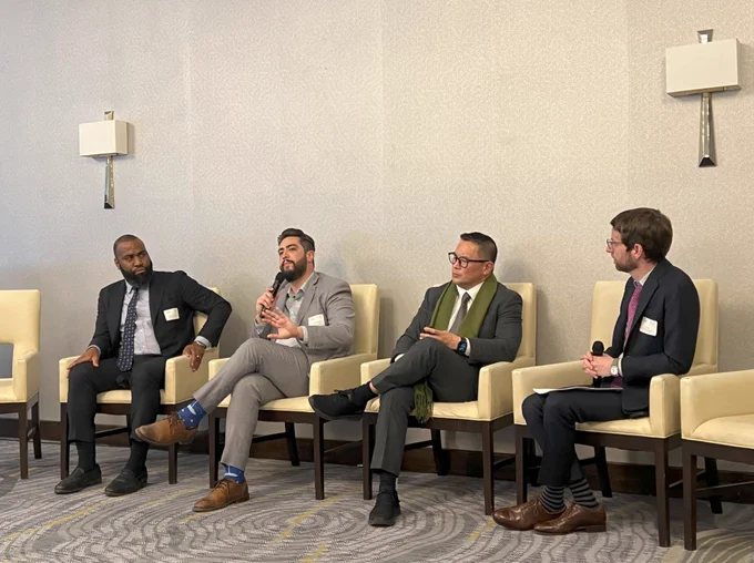 Three photographs of panelists of varying races and genders seated in white chairs inside a room with patterned carpets, beige walls, wall sconces, and large chandeliers. People sit at long and circular tables facing the panel.