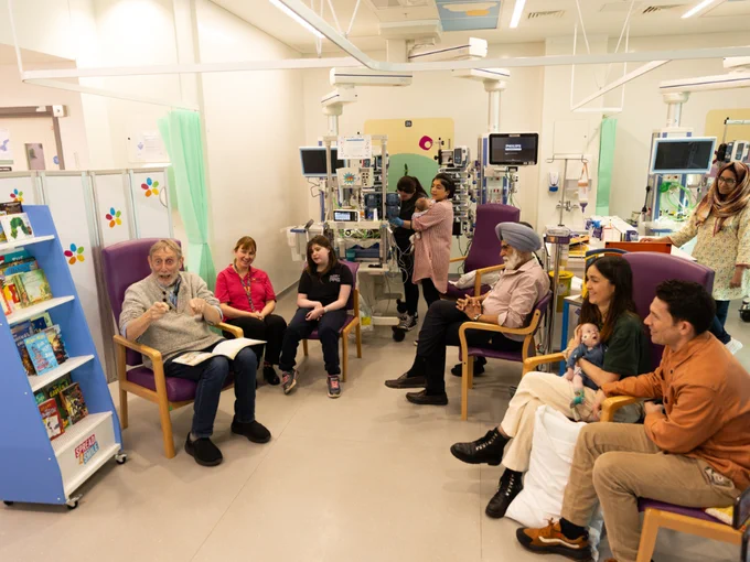 Michael Rosen reading to families in an intensive care unit at Evelina London